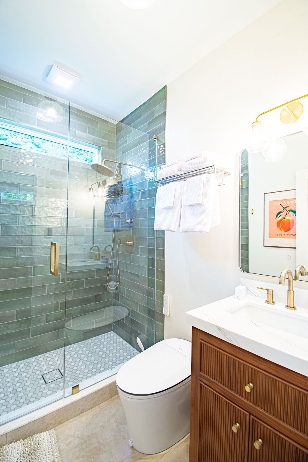 Tiled walk-in glass shower and modern bidet toilet in the ADU bathroom